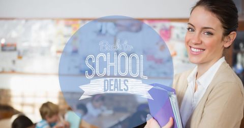 Teacher standing with notebooks in classroom background