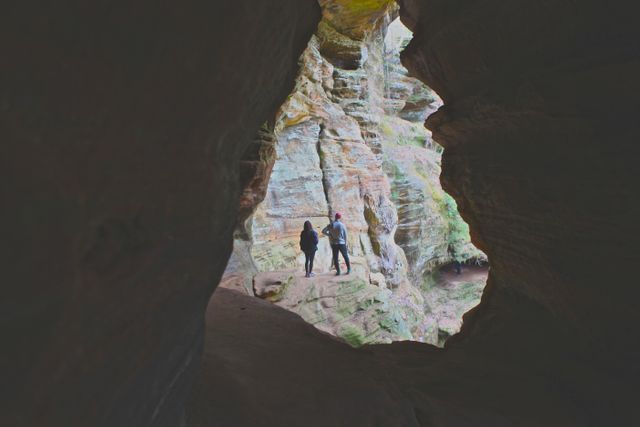 Couple Exploring Rocky Cave Entrance - Download Free Stock Photos Pikwizard.com