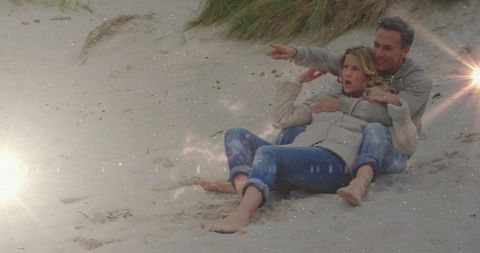 Romantic couple embracing on scenic coastal dunes