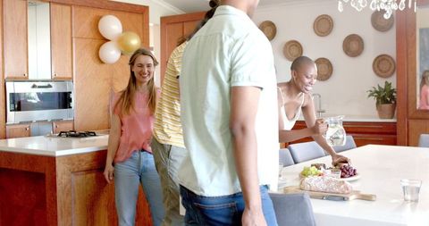Friends Socializing Around Kitchen Island at Relaxed Party Gathering
