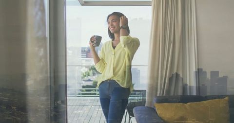 Relaxed Woman Enjoying Morning Coffee by Window