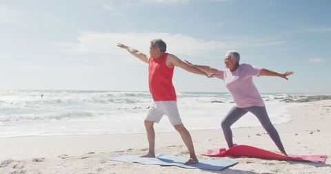 Senior Couple Practicing Yoga on Beach Enjoying Active Lifestyle