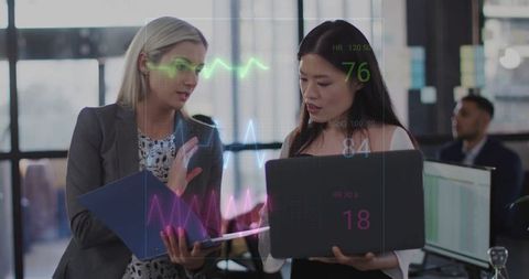 Colleagues reviewing holographic health metrics in modern office