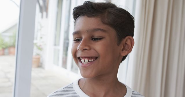 Happy Boy with Missing Tooth Smiling Indoors - Download Free Stock Images Pikwizard.com