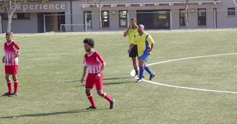 Young Soccer Players and Referee Preparing for Competition on Sunny Day