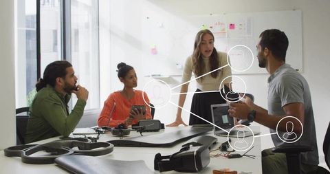 Engineering team collaborating on drone and vr prototype during bright design meeting