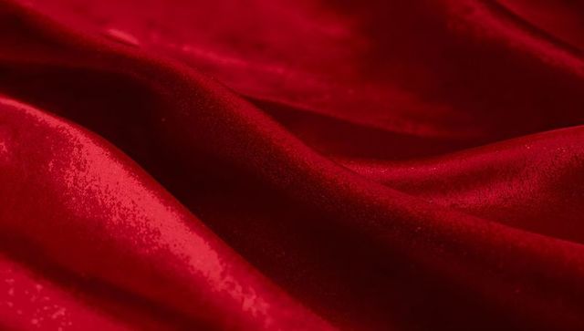 Luxurious red satin fabric with intricate texture and shimmer