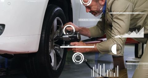 Mechanic tightening wheel lug nuts with pneumatic impact wrench and digital HUD overlays