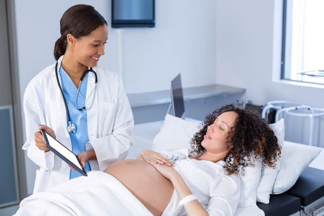 Doctor Showing Ultrasound Scan to Pregnant Woman in Hospital - Download Free Stock Photos Pikwizard.com