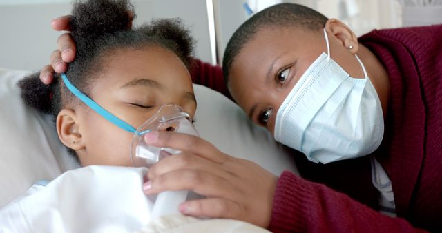 Parent comforting sick child with oxygen mask in hospital - Download Free Stock Images Pikwizard.com