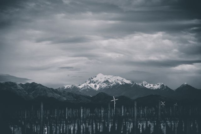 Wind Turbines with Snow-Covered Mountains at Sunset in Black and White - Download Free Stock Photos Pikwizard.com