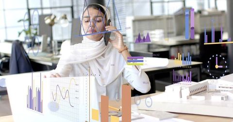 Architect Discussing Projects While Analyzing Digital Charts in Modern Office