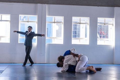Martial Artists Practicing Judo Techniques in Bright Studio