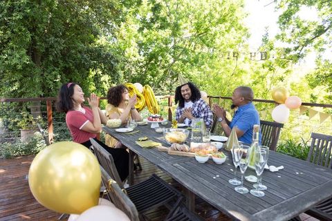 Diverse Friends Celebrating Outdoor Birthday Bash With Joy