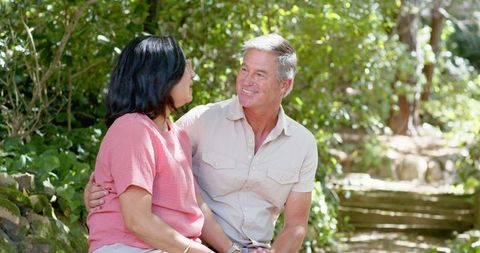 Diverse Senior Couple Enjoying Time Together in Lush Garden Setting