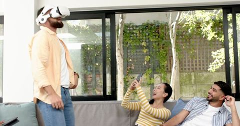 Diverse Friends Experiencing Virtual Reality Together at Home