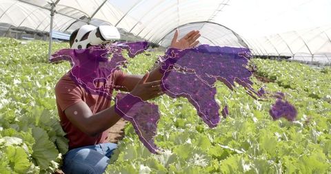 Man Using VR Technology in Greenhouse with Digital Map Projection
