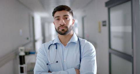 Confident Young Doctor Standing in Hospital Corridor
