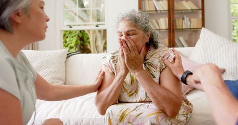 Empathetic Friends Supporting Tired Elderly Woman