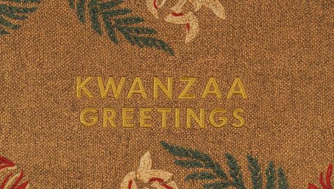 Golden kwanzaa greetings embroidered on woven brown textile with botanical motifs
