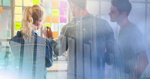 Office team collaborating on project with data overlays