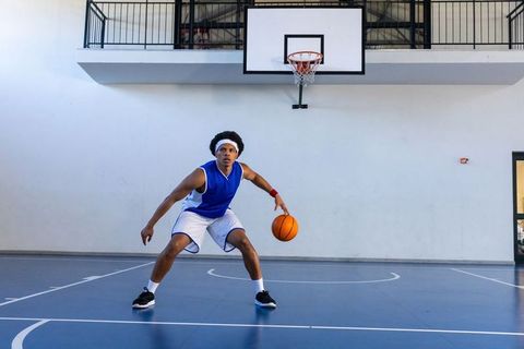 Determined Basketball Player in Action on Indoor Court