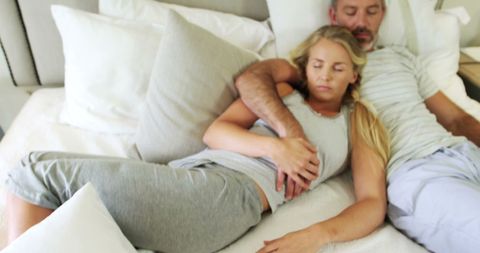 Couple Relaxing in Bedroom Embracing Each Other Peacefully