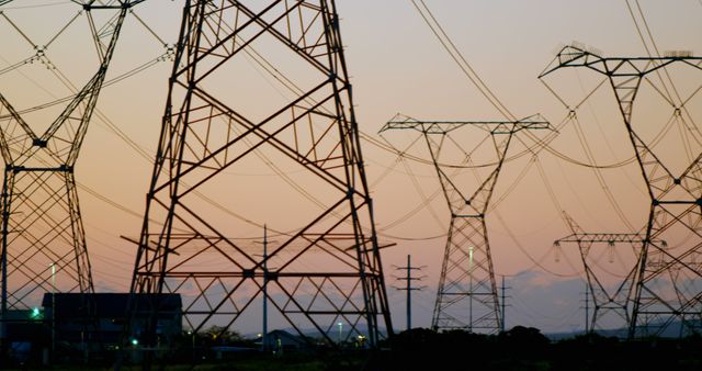 Electricity pylons during sunset at countryside 4k