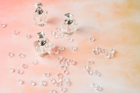 Elegant Crystal Perfume Bottles with Sparkling Gems on Pink Background
