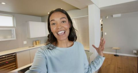Smiling woman creates content in minimalist kitchen space