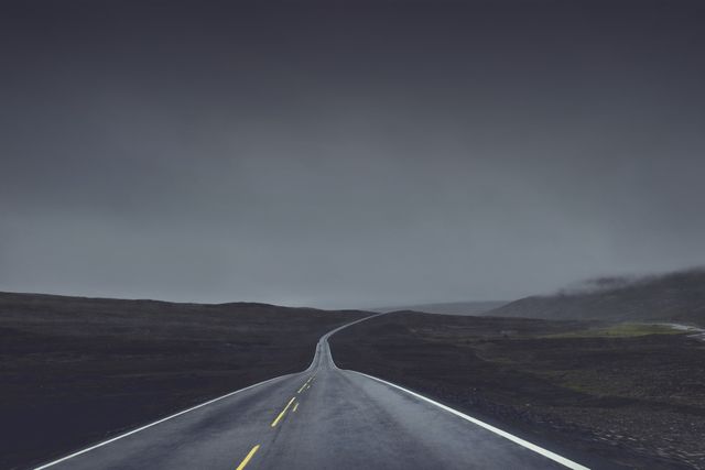 Empty Road Stretching Into Dark Overcast Horizon - Download Free Stock Photos Pikwizard.com