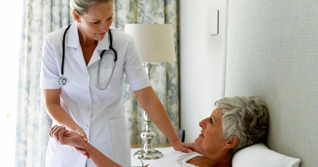 Female Nurse Checking Elderly Patient's Pulse in Hospital Room - Download Free Stock Images Pikwizard.com