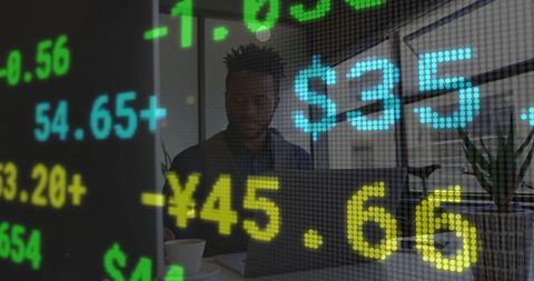 Financial analyst monitoring stock market trends on laptop