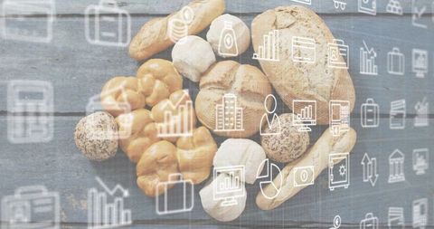 Showcasing rustic bakery bread with business icons overlay on blue-gray woodgrain