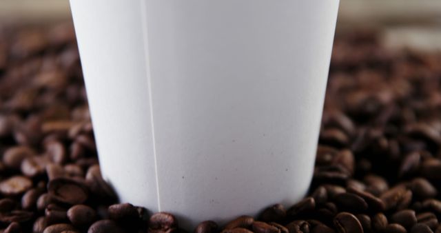 White Paper Coffee Cup Surrounded by Coffee Beans - Download Free Stock Images Pikwizard.com