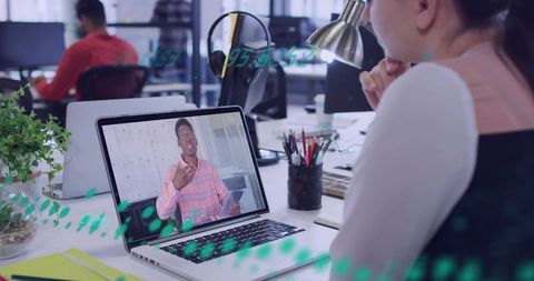 Female professional joining remote video meeting at open office desk with laptop presenter