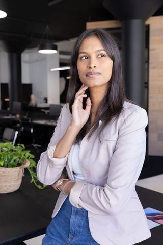 Confident Businesswoman Posing in Modern Open Office