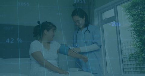 Home healthcare nurse measuring patient's blood pressure