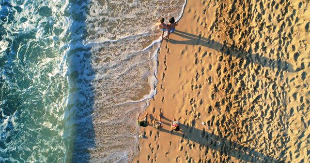 Aerial View of Two People Walking on Sandy Beach - Download Free Stock Images Pikwizard.com