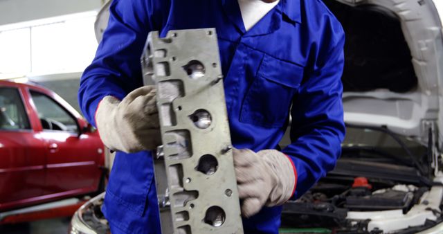 Mechanic inspecting engine component in auto repair shop - Download Free Stock Images Pikwizard.com