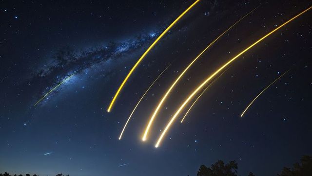 Vibrant Meteor Streaks Under Milky Way in Starry Night Sky