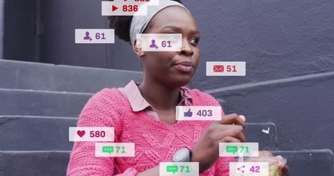 Woman engages with social media alerts while eating outdoors