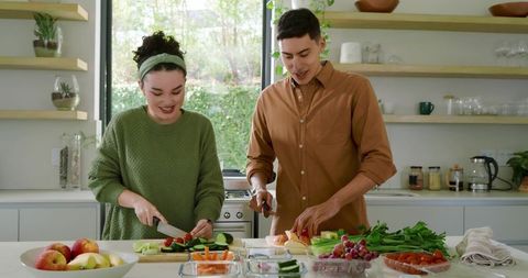 Couple Prepares Fresh Veggies and Fruits in Modern Kitchen