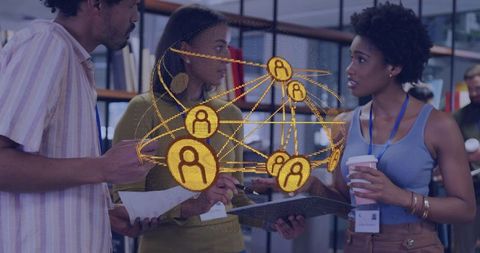 Diverse team collaborating over tablet with golden network overlay in modern coworking hub