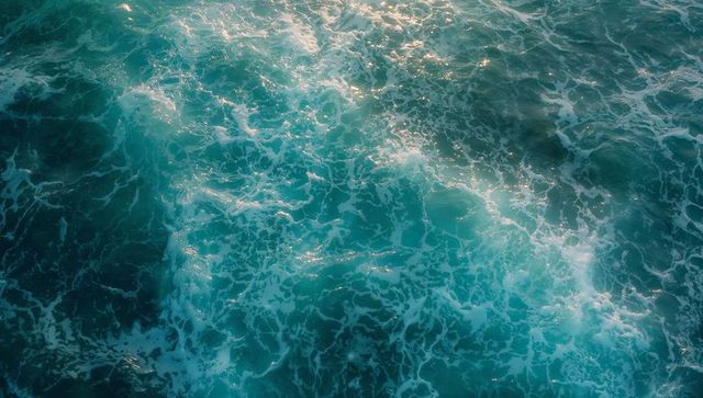 Vibrant ocean ripples reflecting sunlight on open sea surface