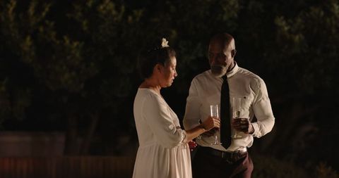 Elderly Couples Night Celebration with Drinks in Garden