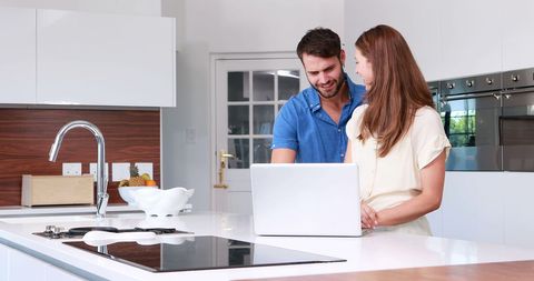 Happy Couple Using Laptop in Kitchen Modern Home - Download Free Stock Images Pikwizard.com
