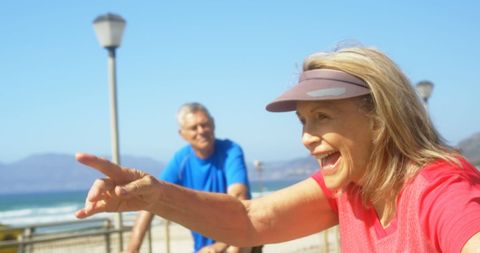 Active Senior Couple Enjoys Beachside Cycling Together