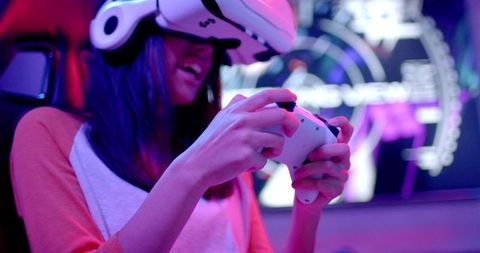 Teenager engaging in virtual reality gaming with headset and controller