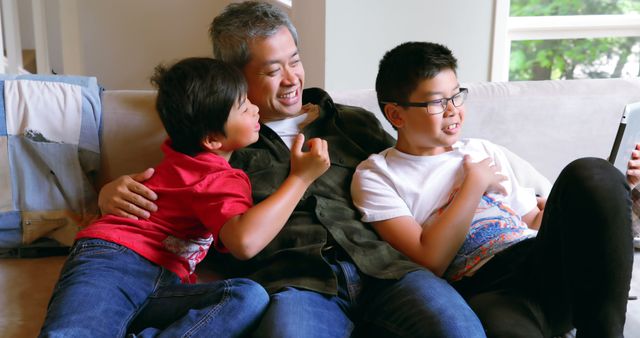Happy Asian Family Bonding on Living Room Couch - Download Free Stock Images Pikwizard.com